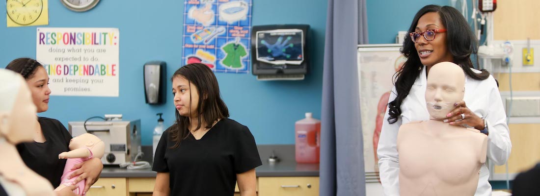 Teacher and students in nursing class